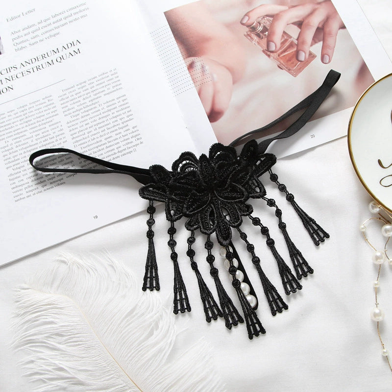 Embroidered low waist pearl massage crotchless thong