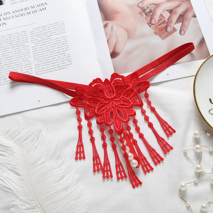 Embroidered low waist pearl massage crotchless thong